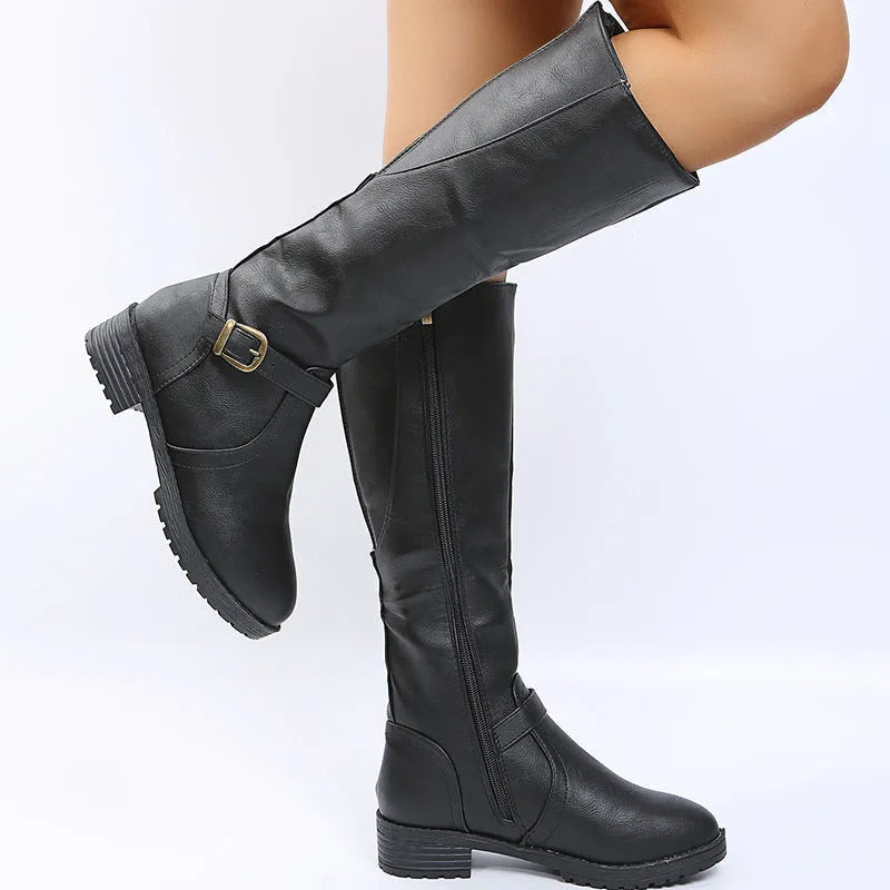Women's black knight-style ankle boots with a buckle strap and square heel on a white background.