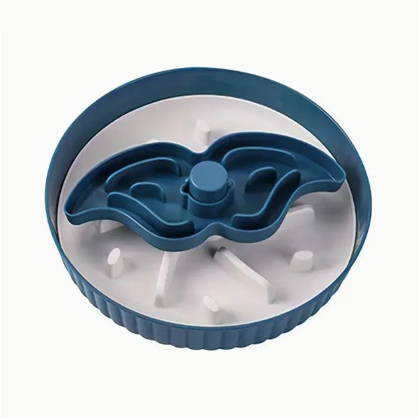 A grey plastic rotating pet bowl with a textured blue silicone slow-feeding mat attached, showing a windmill pattern.