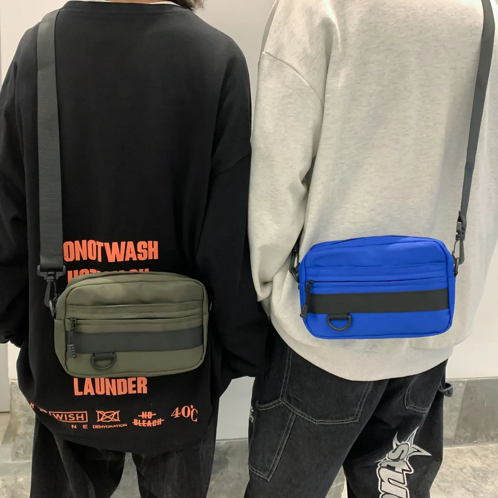 Men's solid color polyester nylon messenger bag with sewing thread detail and crossbody strap in black blue green or white