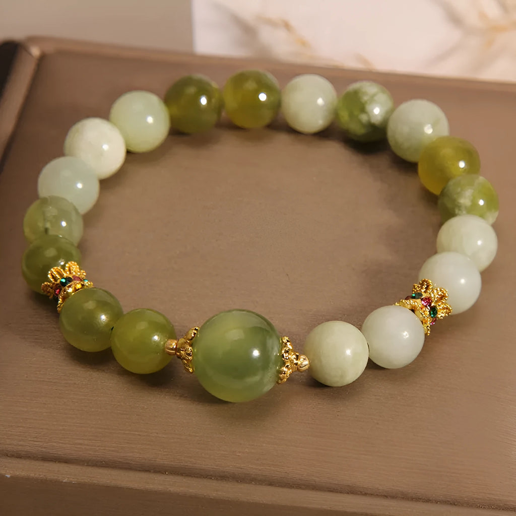 Xiuyan jade green women's bracelet with original design on a wrist.