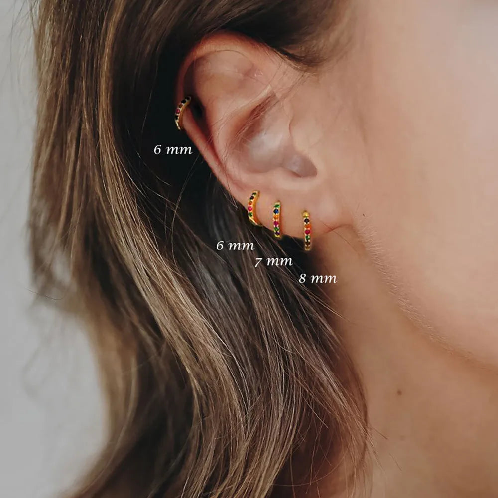 Perforated circle zircon stud earrings in gold colour with geometric pattern and butterfly clasp