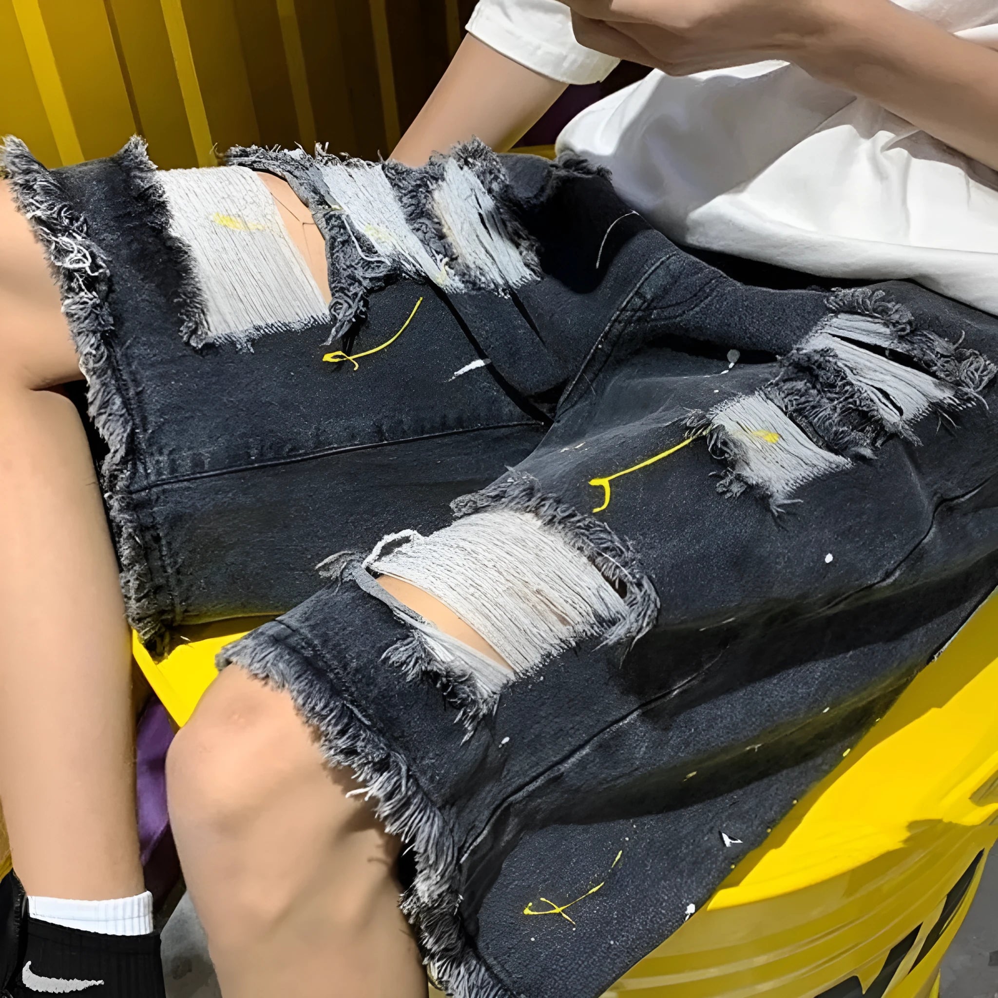 Men's casual denim shorts with water washed distressing and loose street style fit