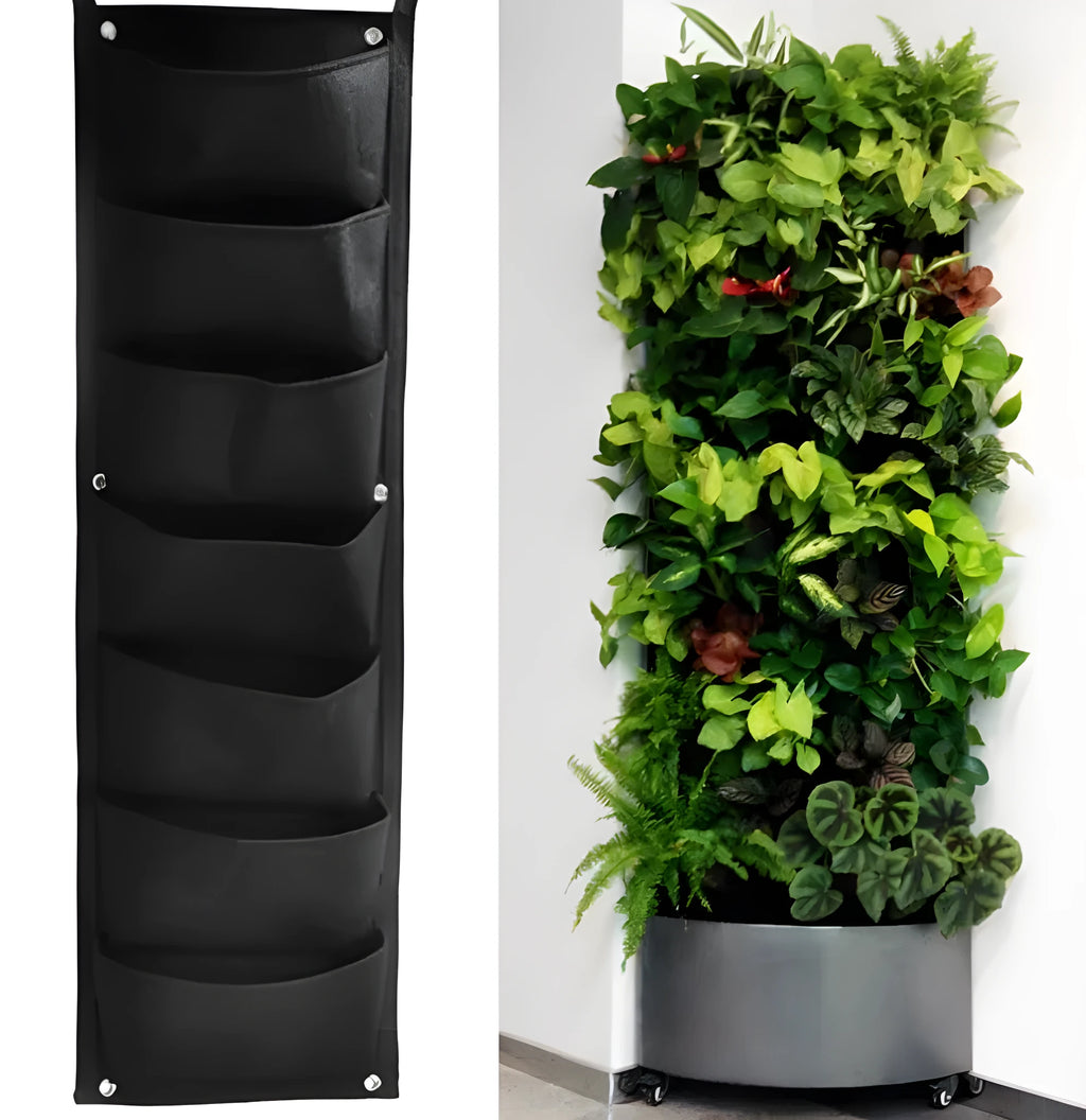Green felt vertical wall planter with multiple planting pockets hung on an outdoor fence