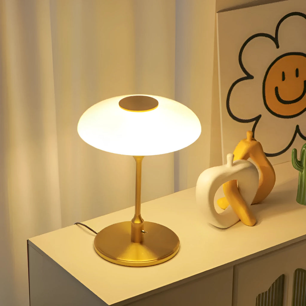 Korean style golden orange atmosphere light with metal base on a bedside table.