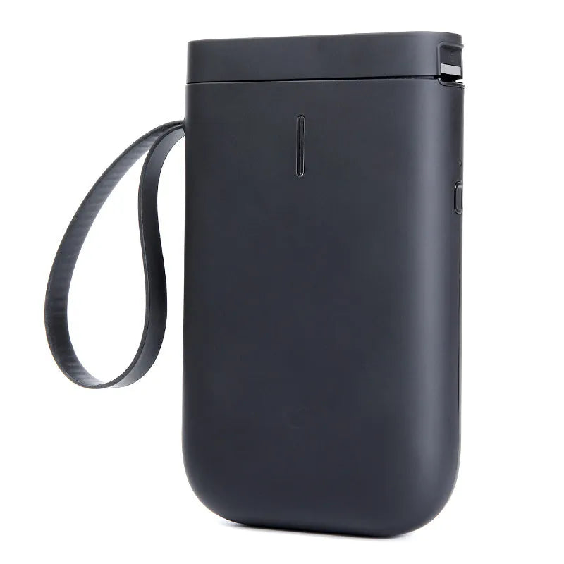 D11 compact white Bluetooth thermal label printer with USB cable and roll of label paper on a desk.