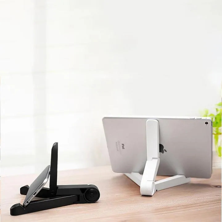 Black foldable tablet holder open on a desk supporting a tablet in landscape mode.