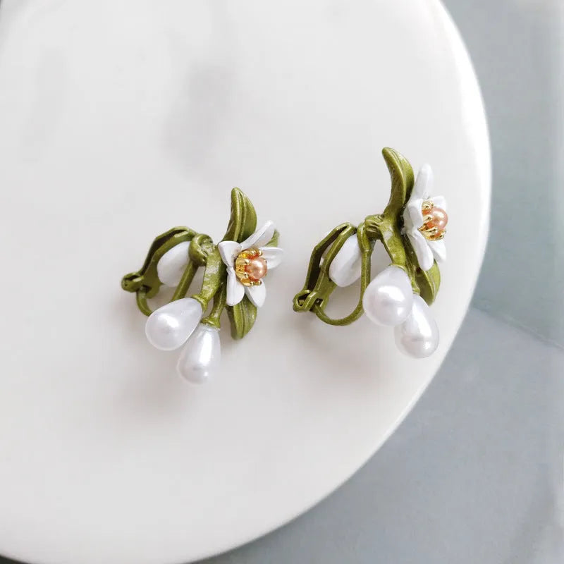 Women's alloy flower earrings with sterling silver needle contrasting colour detail, shown in clip-on and stud styles