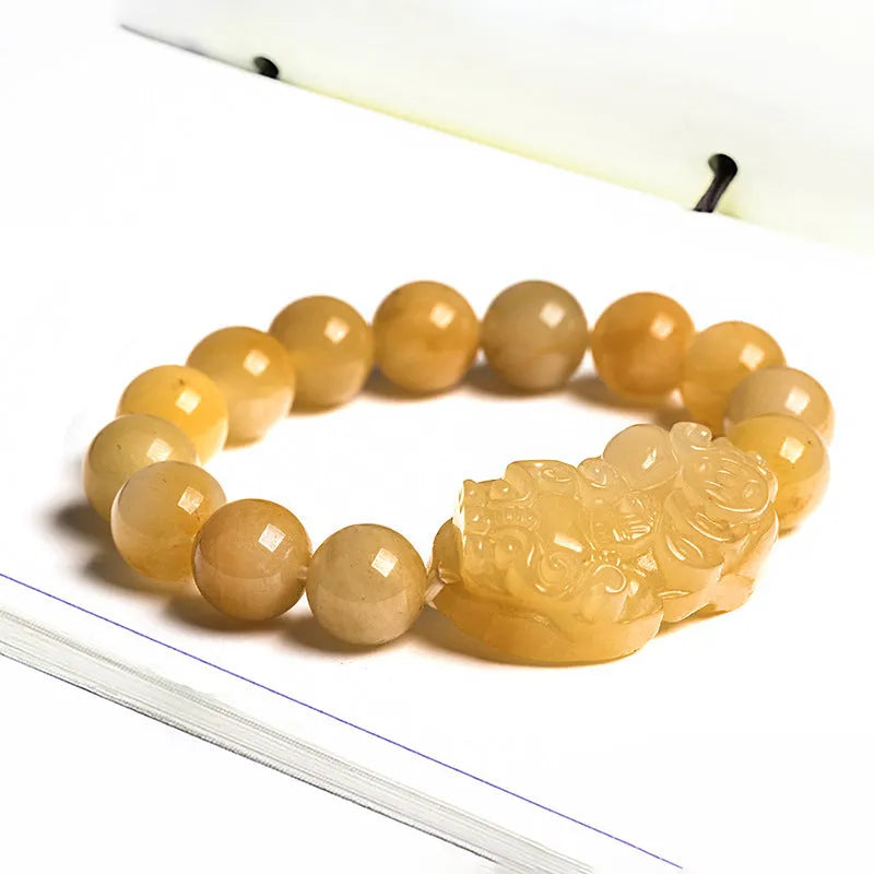 Carved Jinsi jade money bracelet showing golden thread texture and bead details
