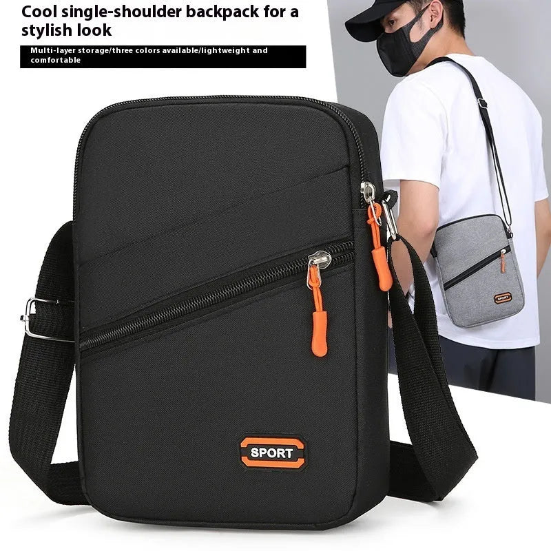 Lightweight solid colour oxford cloth crossbody commuter bag in black, navy, or silver grey.