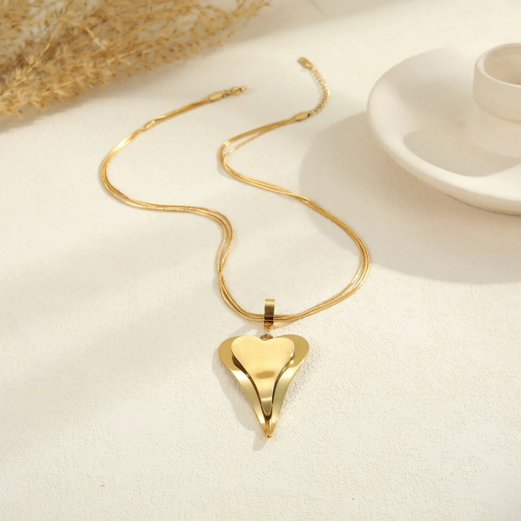 Stainless steel women's necklace with geometric double heart pendant and snake bones chain in gold or steel finish