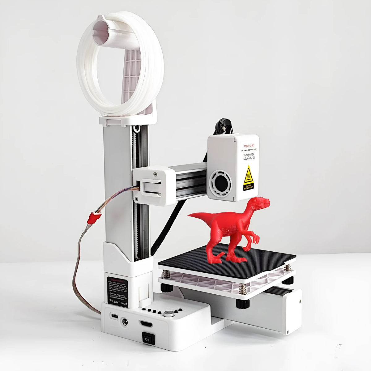 White EasyThreed K10 3D printer on a desk with power cord and manual