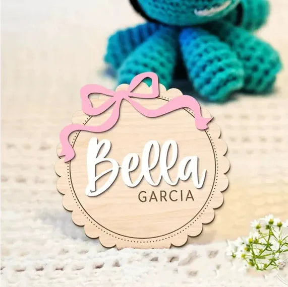Customised square wooden baby ornament with a name for birthday or holiday decoration.