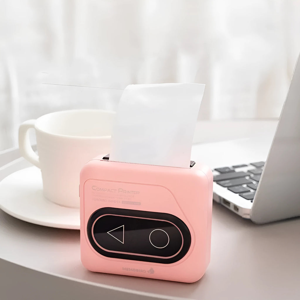 Avocado green coloured portable Bluetooth thermal mini printer next to a mobile phone