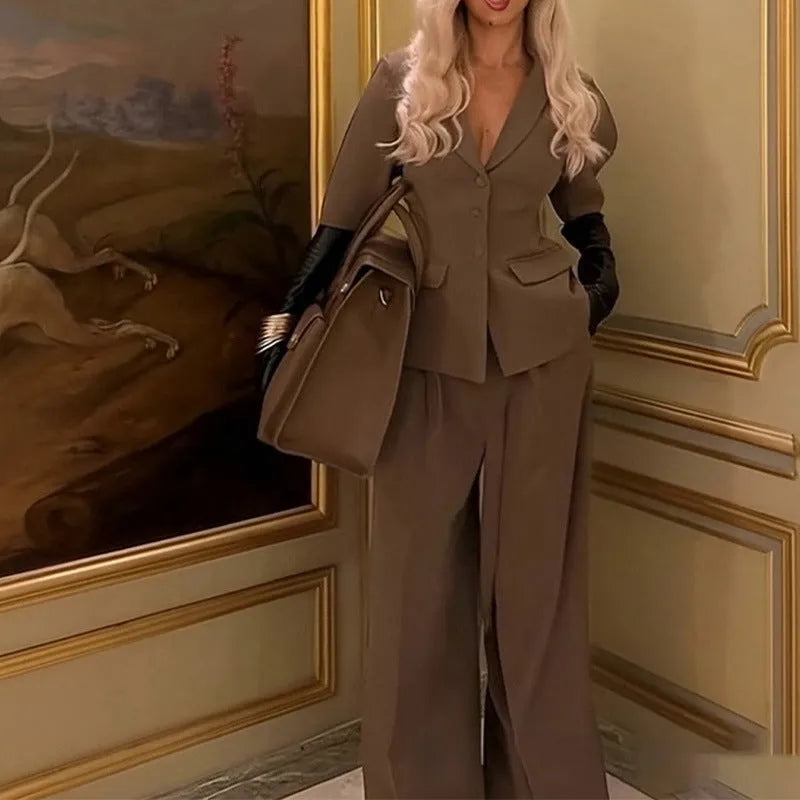 Brown slim fit two-piece polyester suit on a hanger, showing the long sleeve top and trousers.