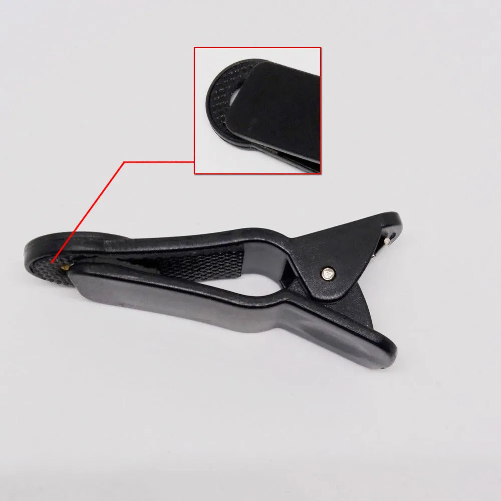 A long black telescopic lens with a universal collar clip for attaching to mobile phones.