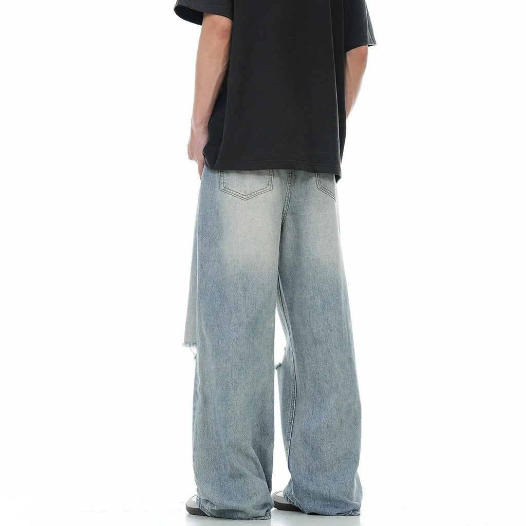 Blue straight-leg men's jeans with a zipper fly on a plain background.