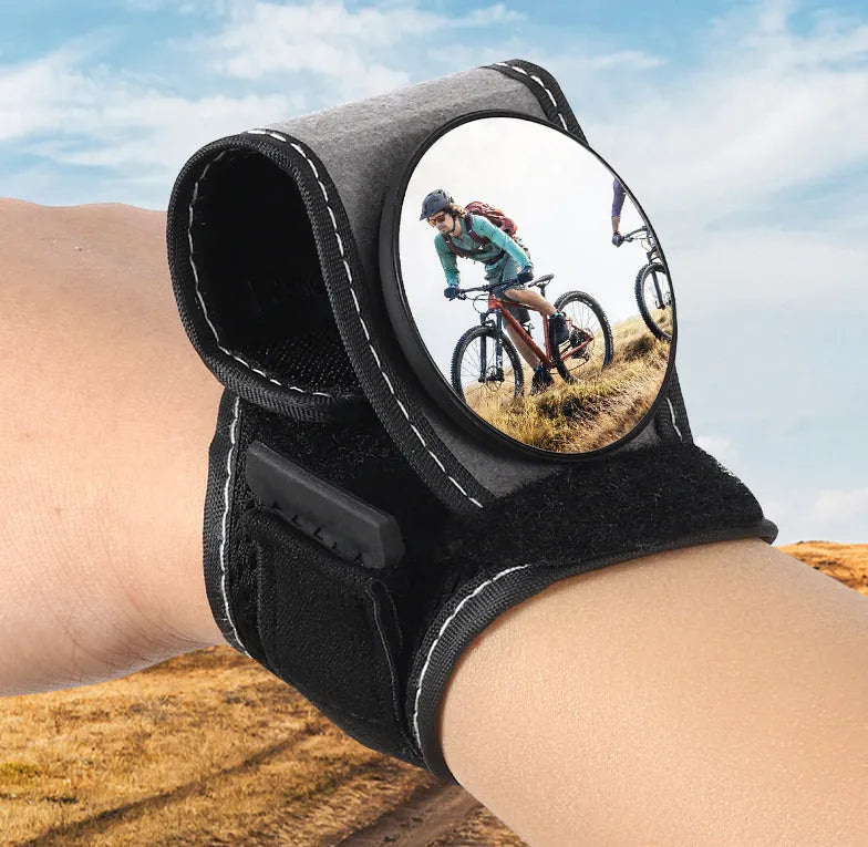 Black wrist-mounted bicycle rear-view mirror showing nylon construction and adjustable viewing angle