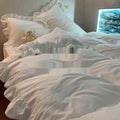 Mori style solid colour washed cotton bedding four-piece set with quilt cover on a bed.