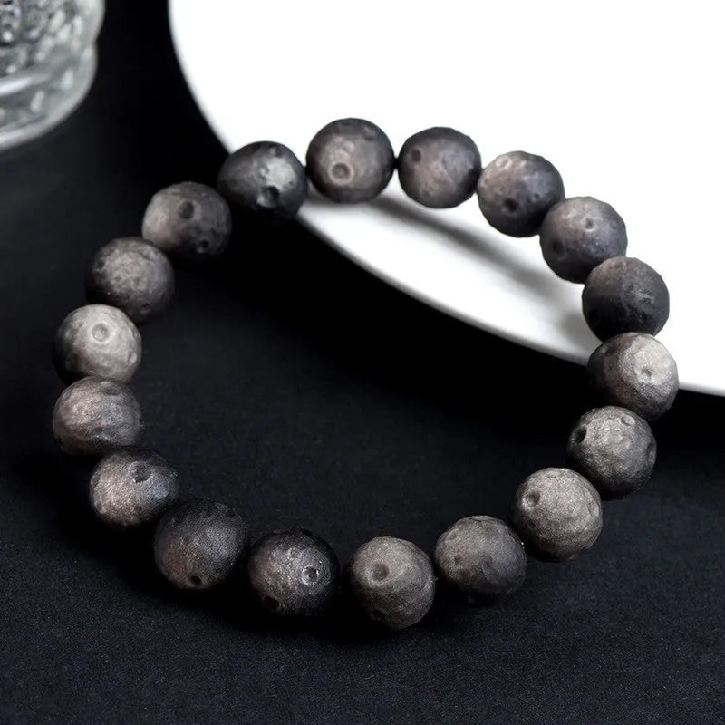 Obsidian crater ball bracelet with natural grinding texture in silver stone meteorite colour