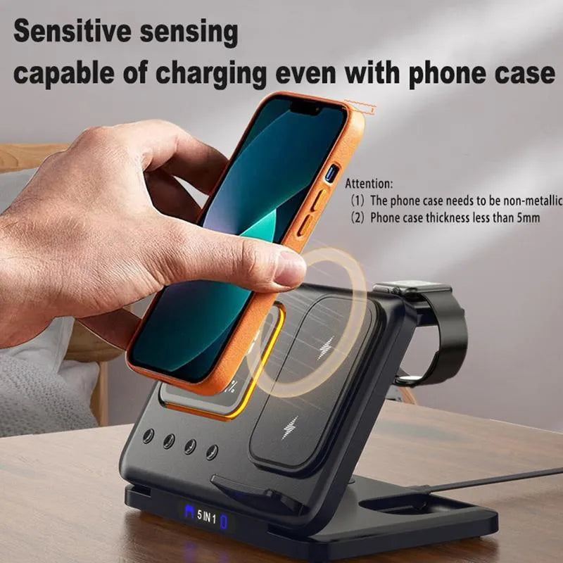 Black wireless charging station with digital clock display showing time and temperature, charging smartphone and smartwatch