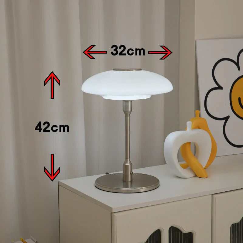 Korean style golden orange atmosphere light with metal base on a bedside table.