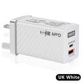 Compact white 65W Gallium Nitride laptop charger with UK, US and EU plug attachments on a desk.