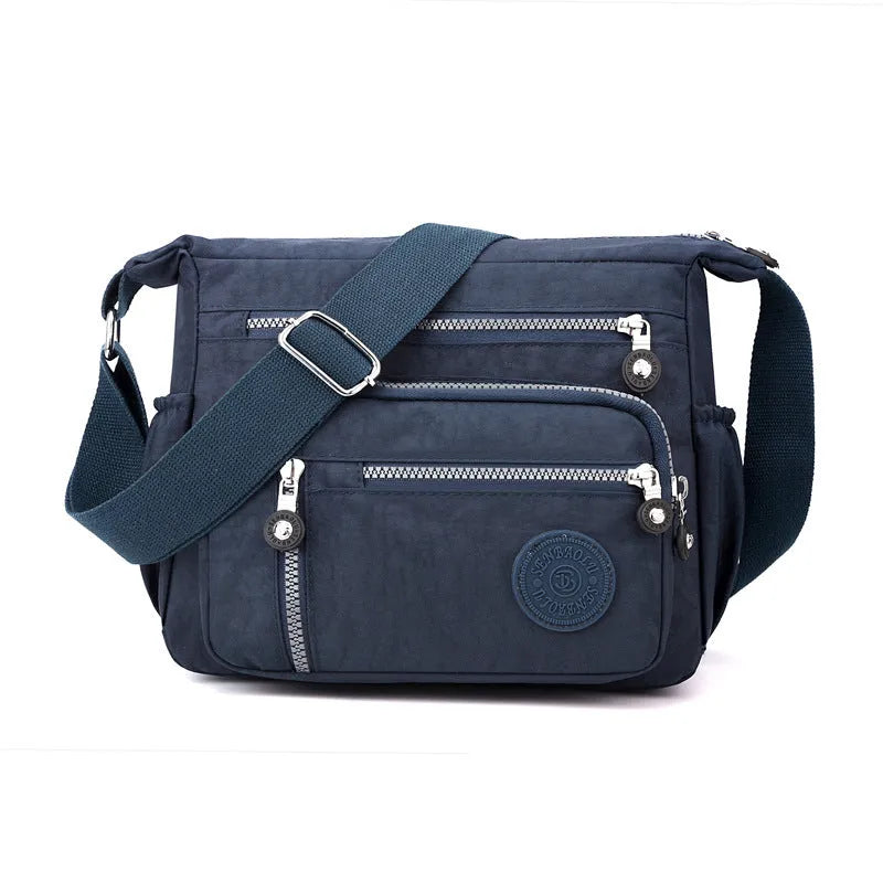 Grey soft nylon messenger bag with single shoulder strap showing square vertical shape