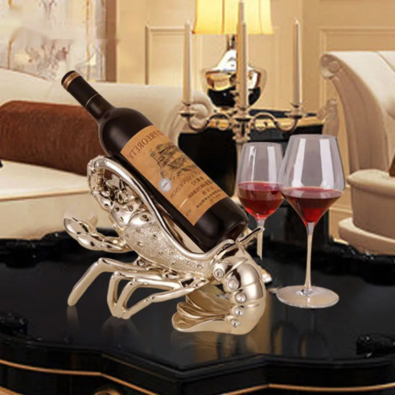Lobster-shaped wine rack ornament in rose gold or silver, holding a wine bottle.