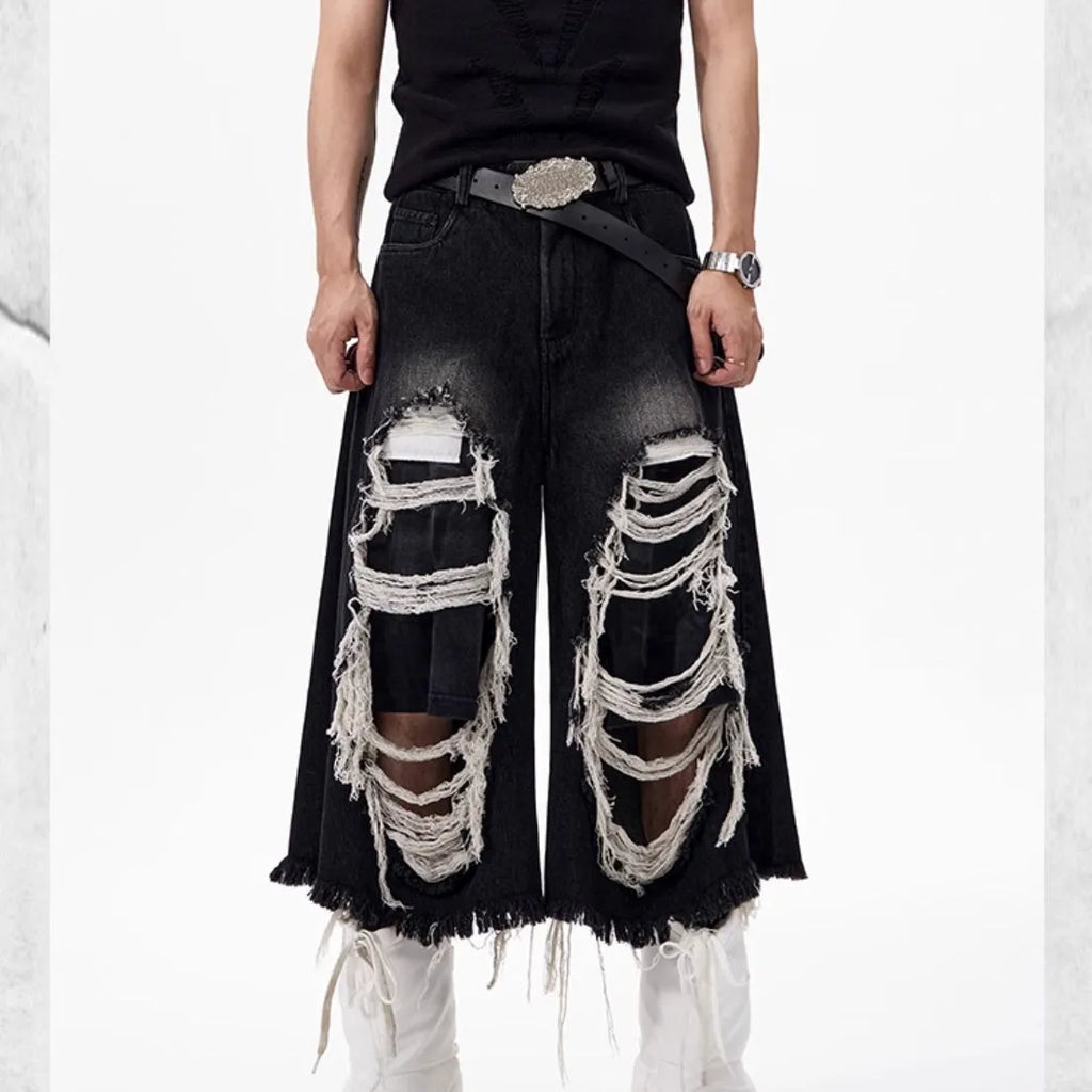 Black cropped wide-leg women's jeans with ripped patch details and mid-high waist