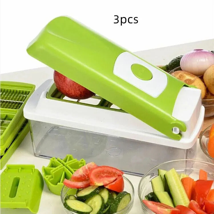 Green manual food chopper with multiple stainless steel accessories on a kitchen counter.