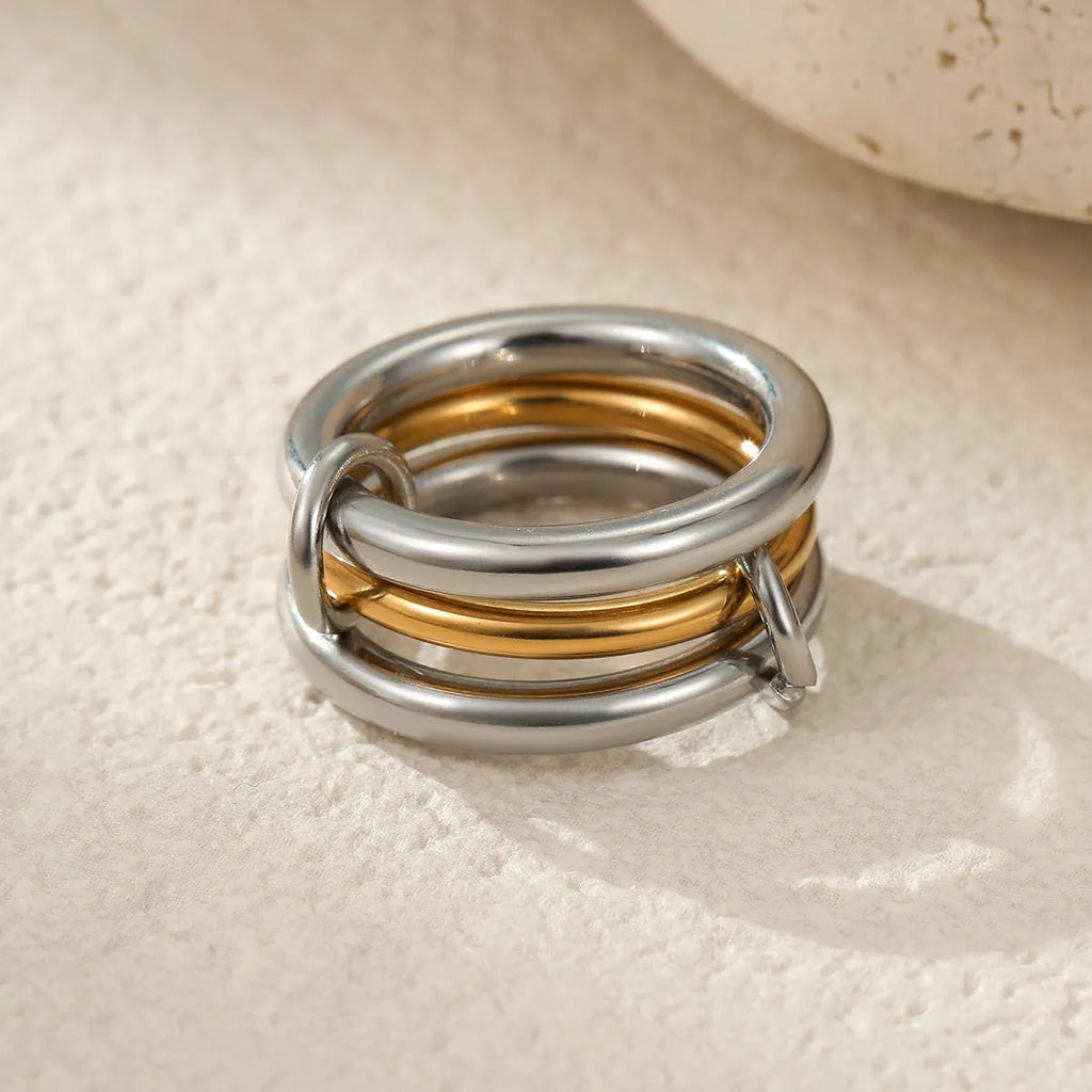 Gold plated stainless steel stacked ring set in three colour variants on a hand.