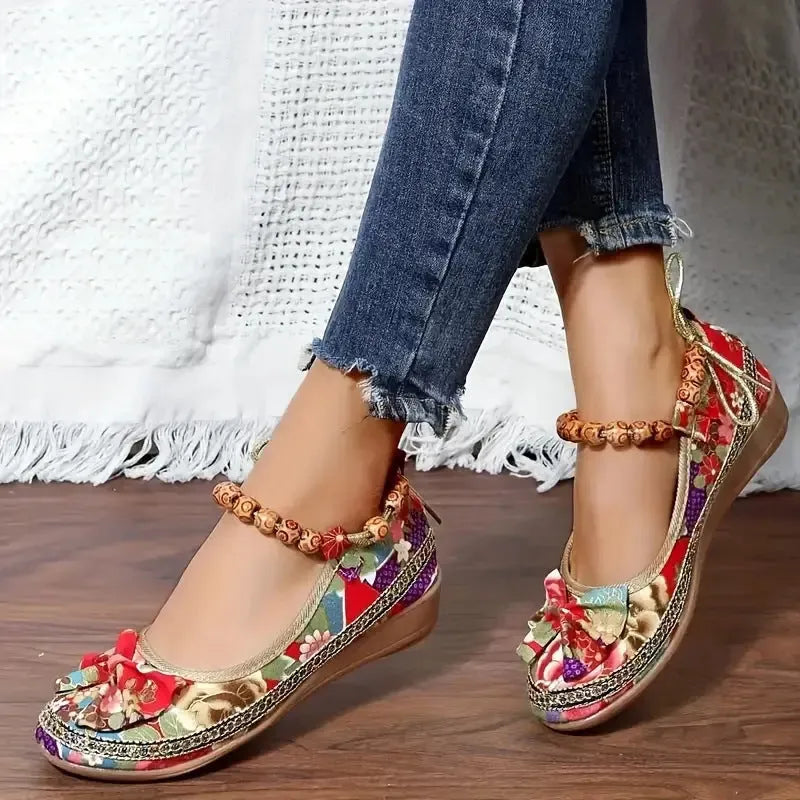 Women's black plus size ethnic platform sandals with cloth upper and elastic band.
