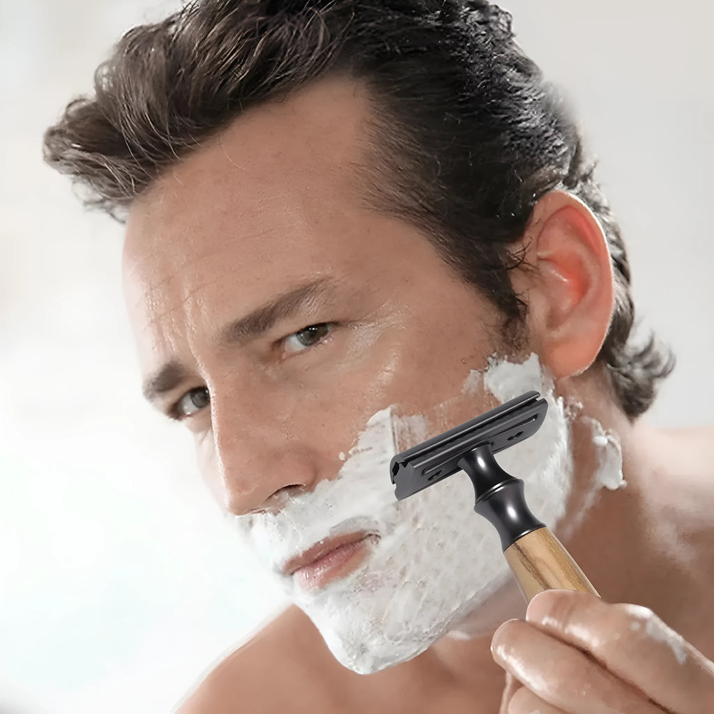 Men's copper safety razor with olive wood handle, blade holder stand, and shaving accessories
