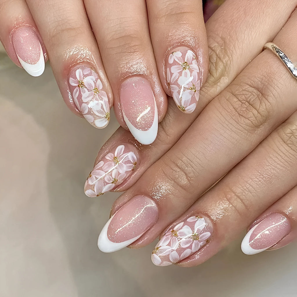 Short almond shaped false nails with glossy finish and glitter flower French tip design colour C625