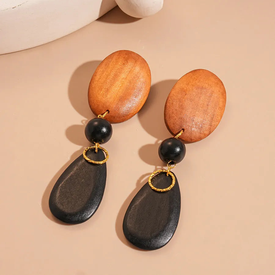 Women's brown-black wooden elliptical earrings with silver needle detailing