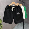 Men's white casual sports shorts with micro elasticity fabric on man at beach