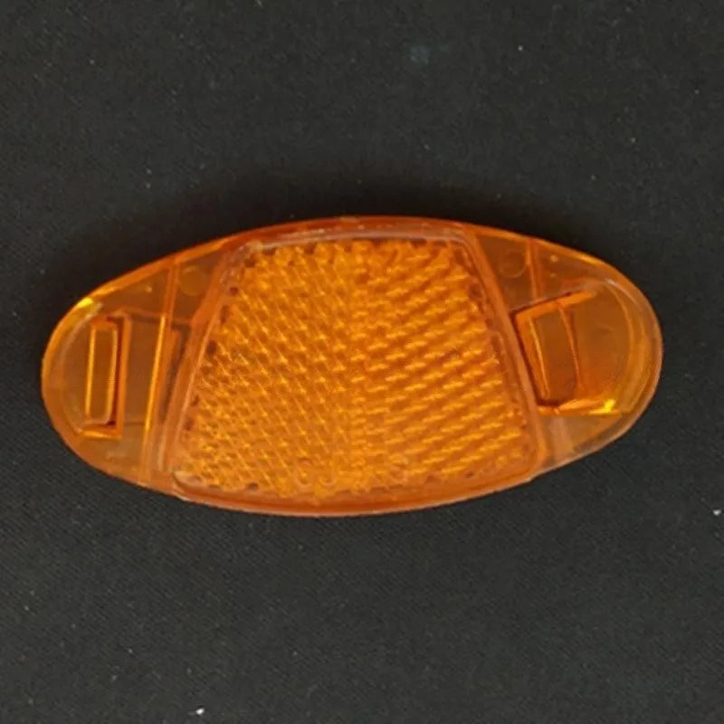 Yellow and white plastic bicycle reflector decorations mounted on wheel spokes for night safety