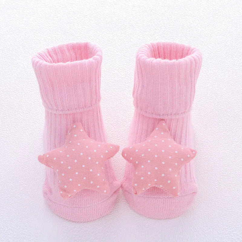 Cotton baby floor socks in various designs including blue bow and lion, showing sizes for infants 0-3 months