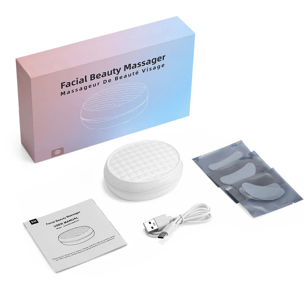 White wireless handheld red light and EMS eye and facial beauty massager device.