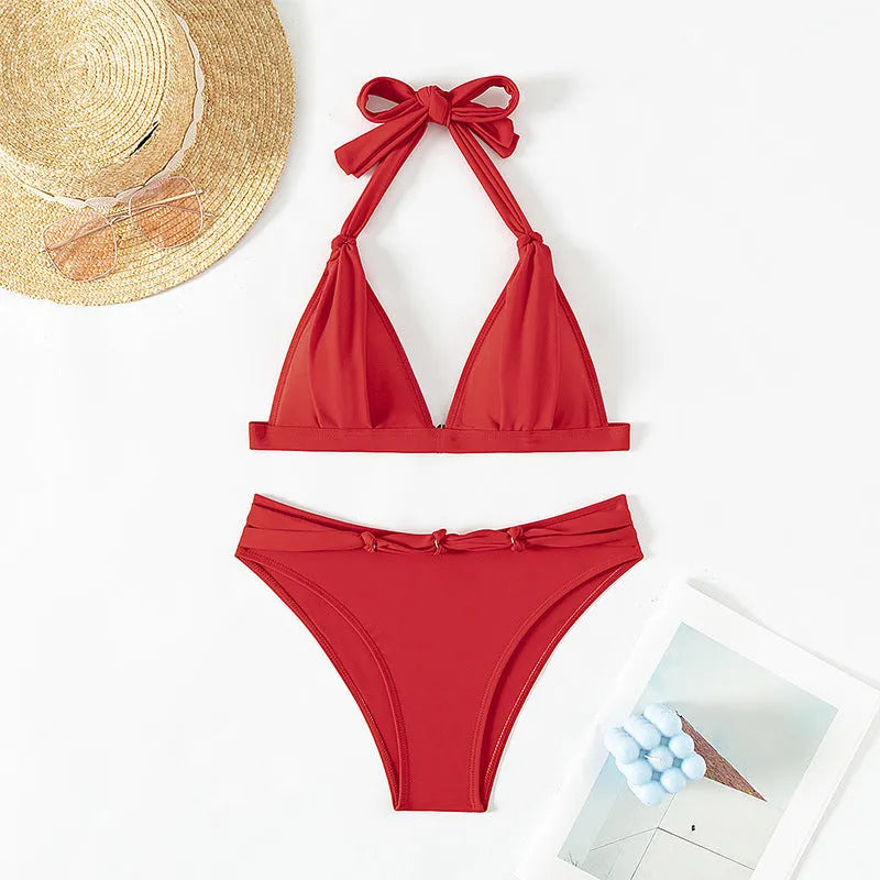Red women's lace-up halterneck bikini set with matching split beach shorts.