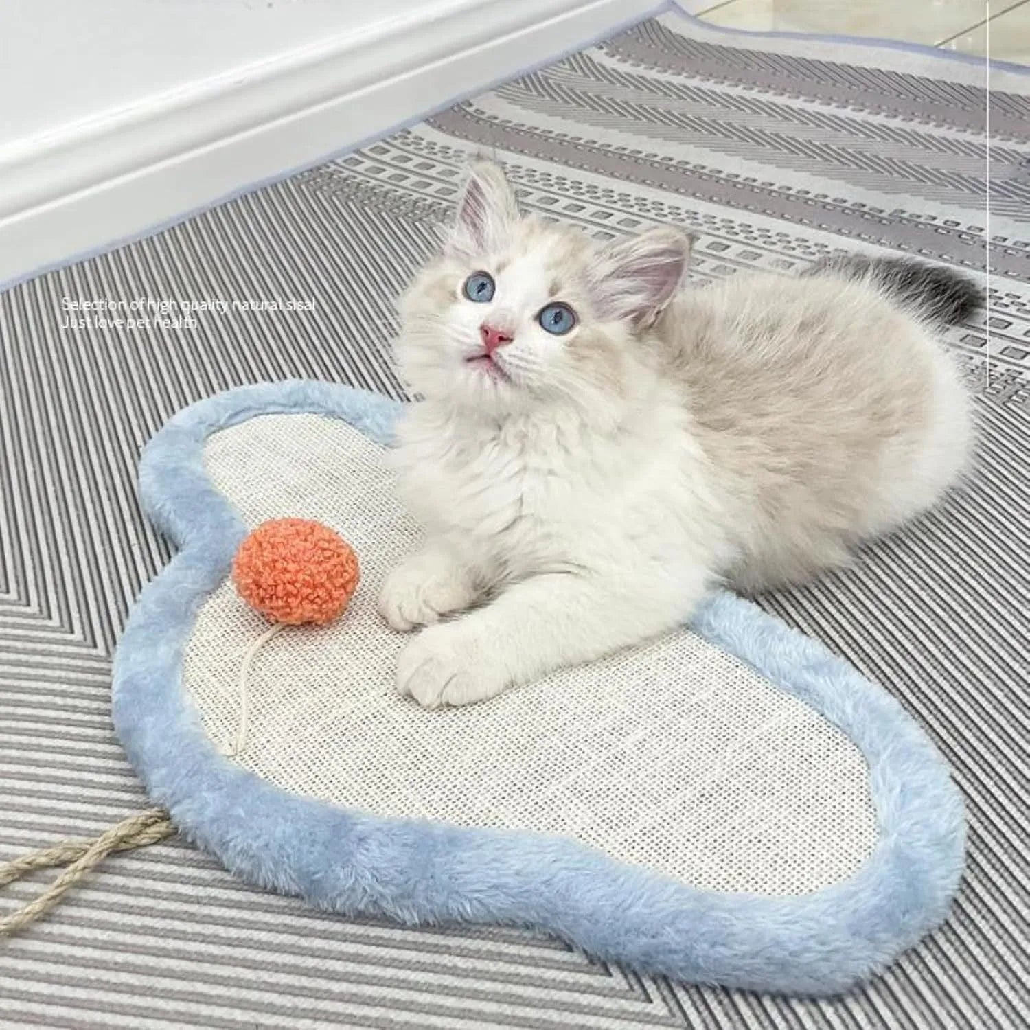 White wall-mounted cat scratching mat with natural sisal surface and sleeping cat cartoon design