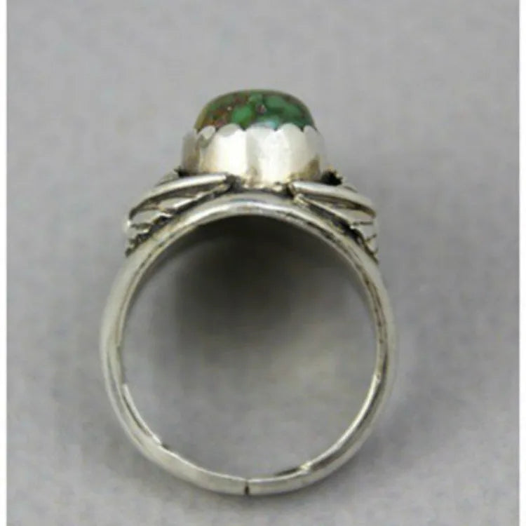 Geometric silver-toned women's ring with a central inlaid turquoise blue stone on a white background.