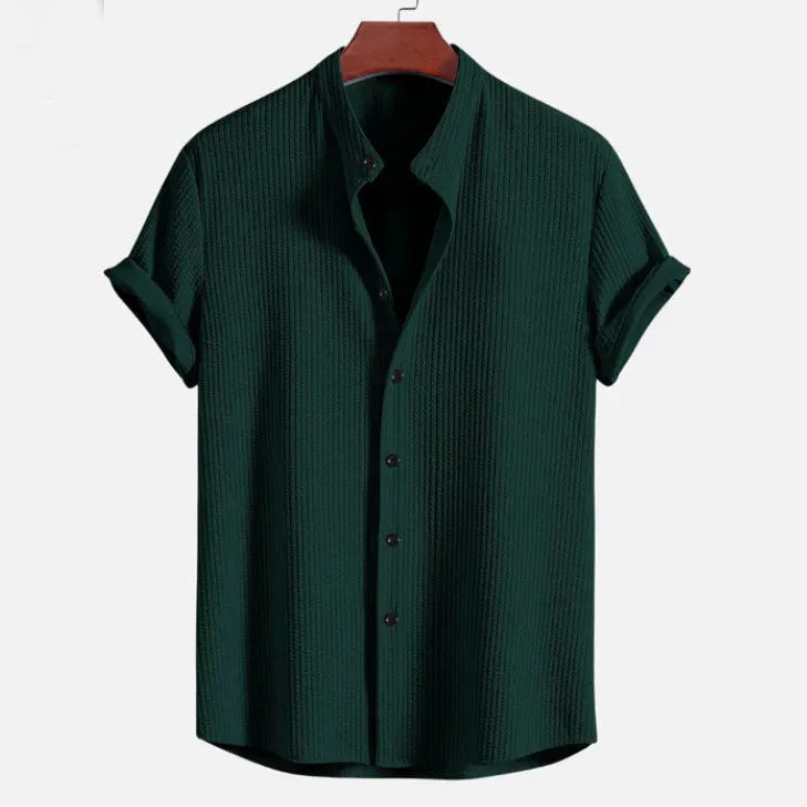 Man wearing a loose-fitting short sleeve polyester shirt in light blue, showcasing the casual summer style.