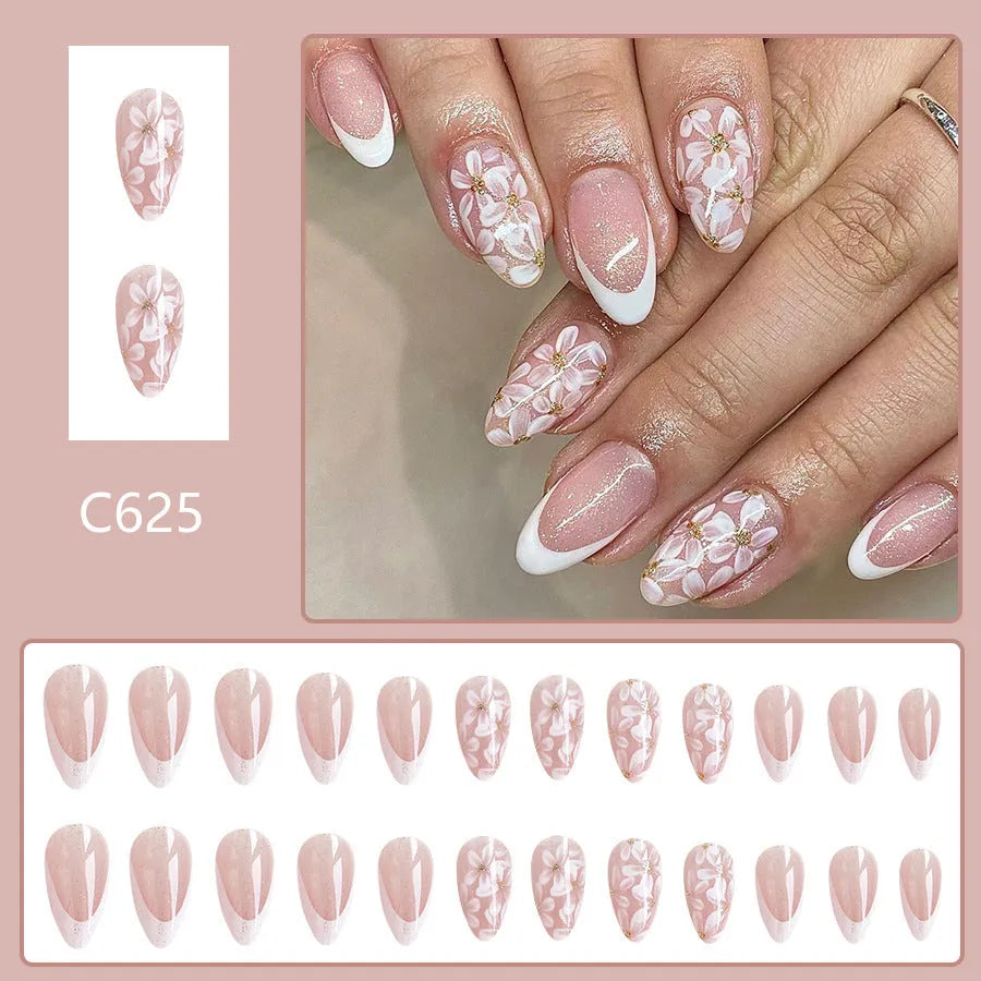 Short almond shaped false nails with glossy finish and glitter flower French tip design colour C625