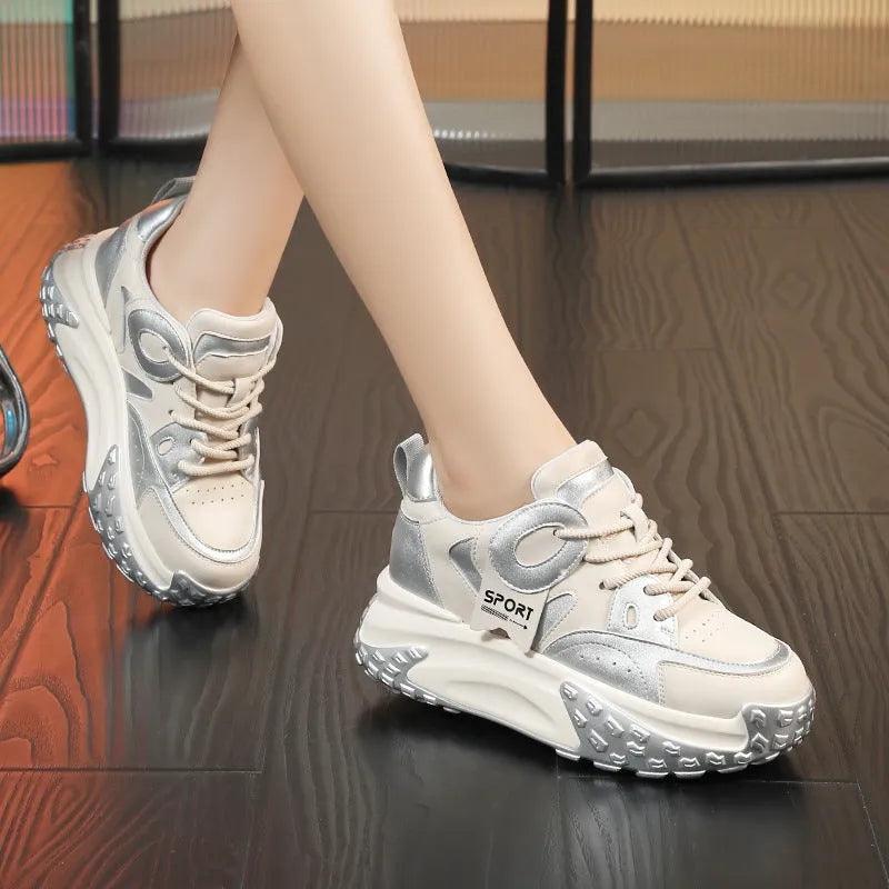 A pair of thick-soled leather casual shoes with a wedge heel and lace-up front fastening.