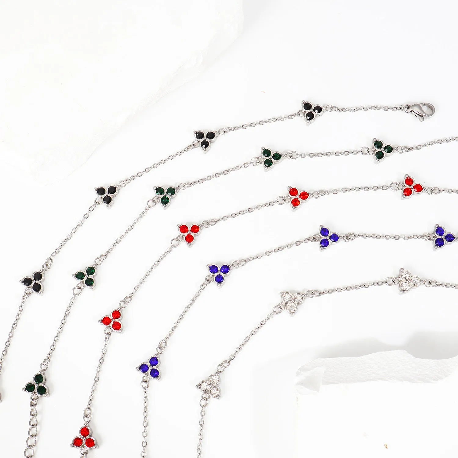 Stainless steel women's bracelet with three geometric diamond shapes and triangle elements
