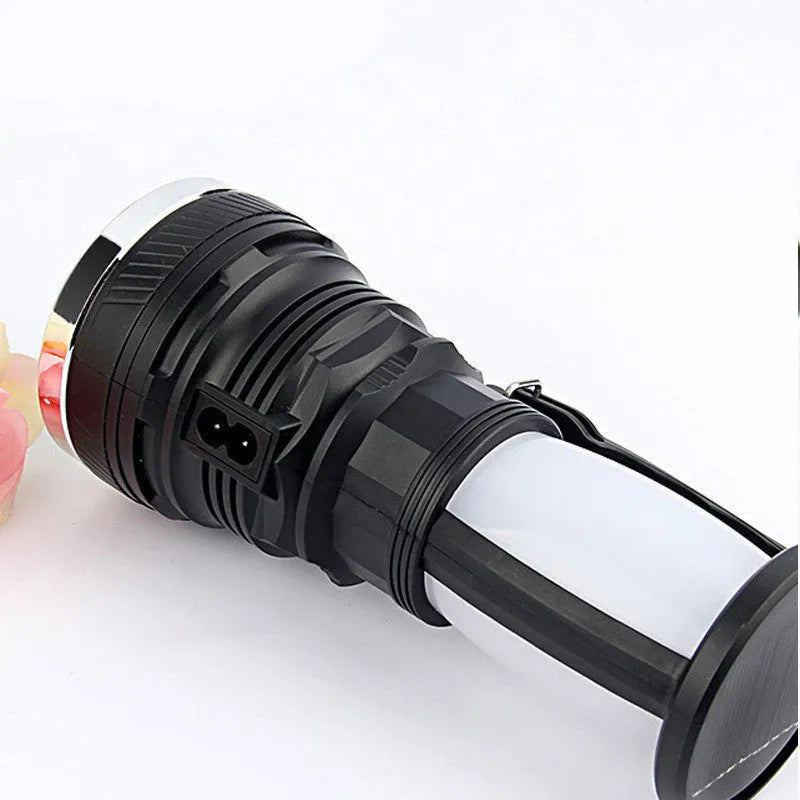 Black solar-powered LED flashlight with USB charging port.