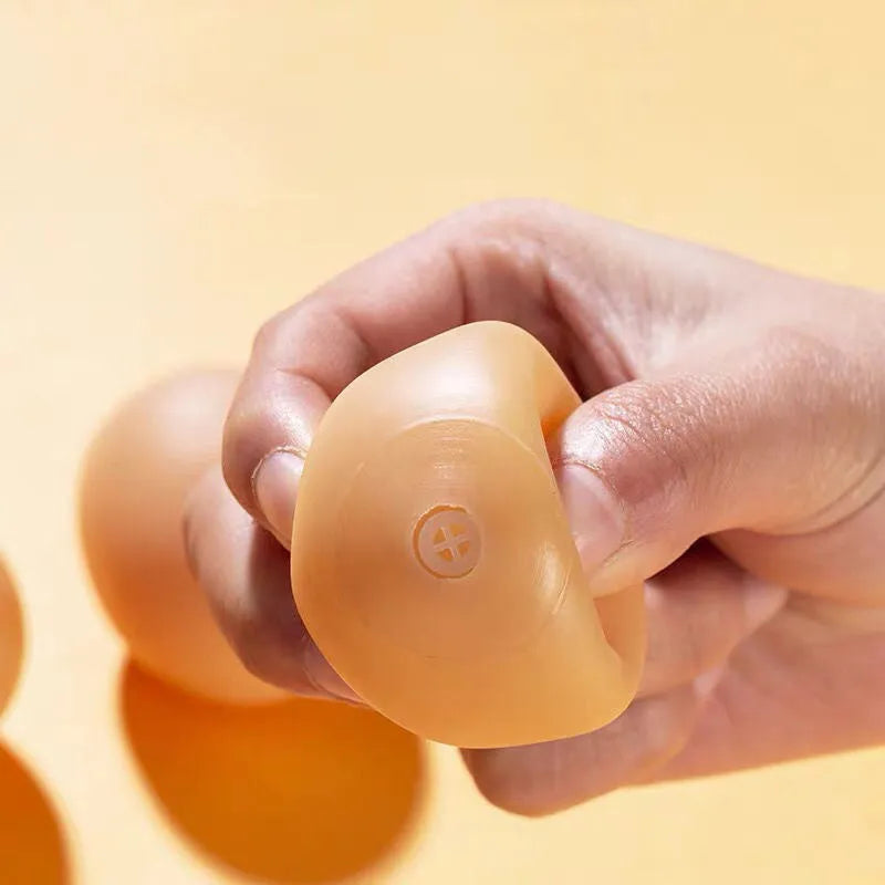 Orange rubber egg-shaped dog chew toy with crinkly sound for small medium breeds