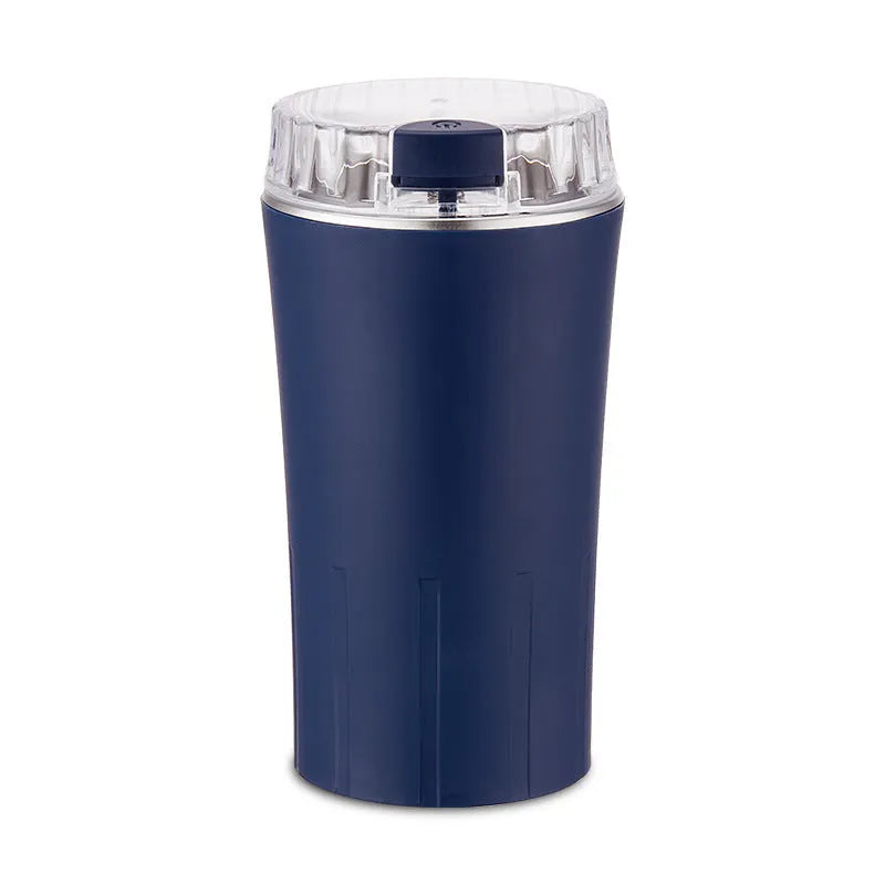 Blue mini flour mill and grain grinder machine with stainless steel construction on a kitchen counter.