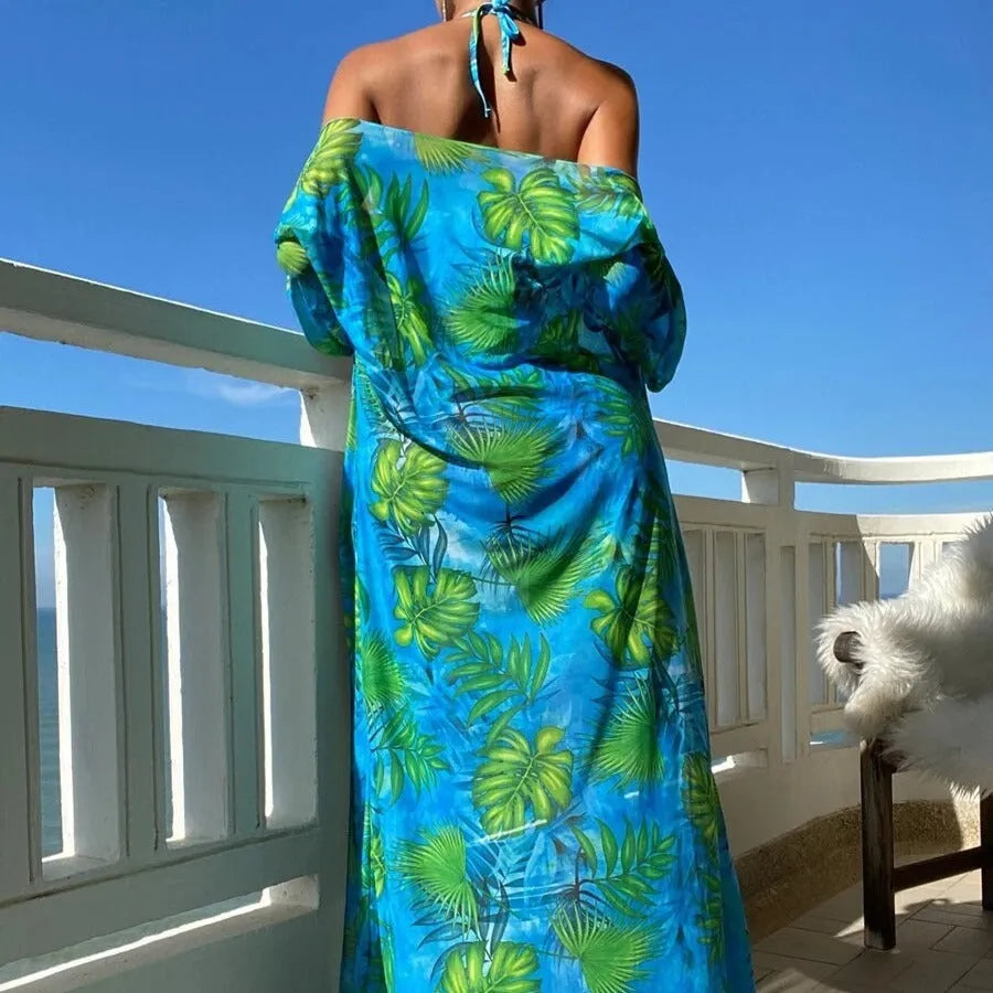 Women's blue long sleeve bikini top and banded briefs with a matching robe laid flat.